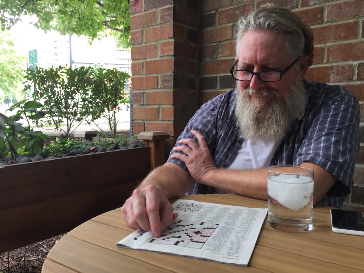 Eric Staats works on a crossword puzzle July 2017 in Arlington, Virginia. Crossword puzzles was one of Eric’s favorite pastimes. (Photo by Vonna Keomanyvong)