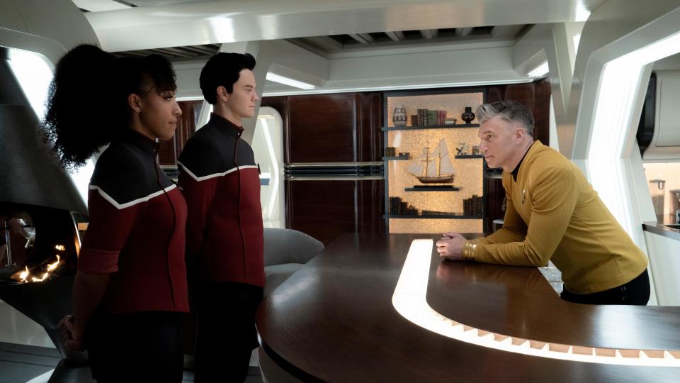 Scene from the T.V. show Star Trek: Strange New Worlds. Here we see 2 younger officers talking to an older officer.