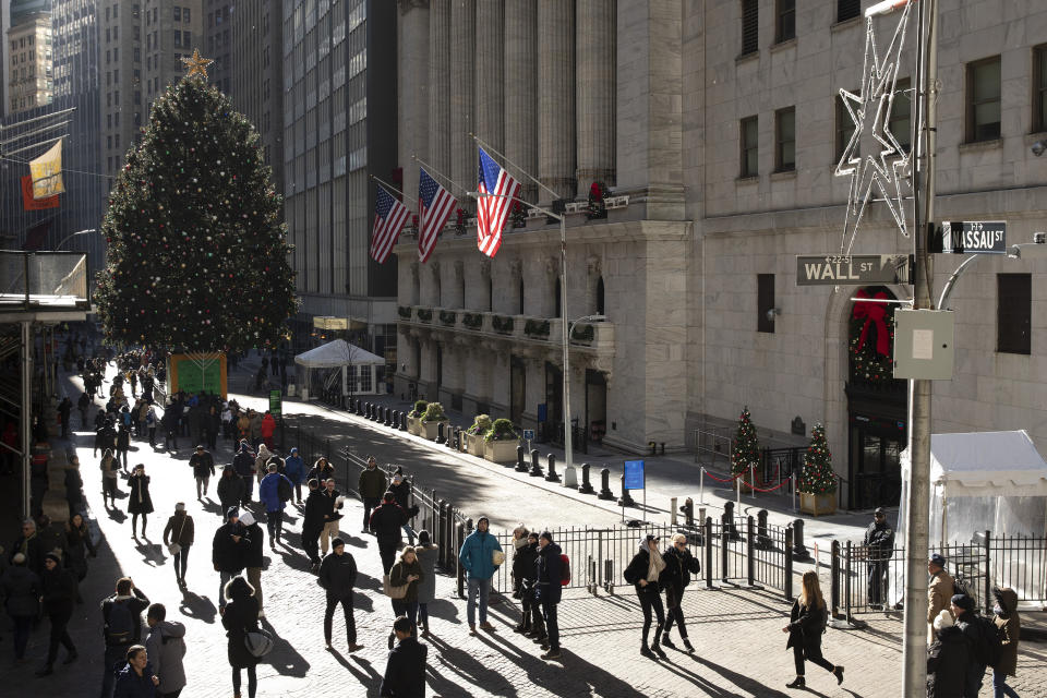 People walk by the New York Stock Exchange, Tuesday, Dec. 3, 2019. Stocks fell broadly Tuesday after President Donald Trump cast doubt over the potential for a trade deal with China this year and threatened to impose tariffs on French goods. (AP Photo/Mark Lennihan)