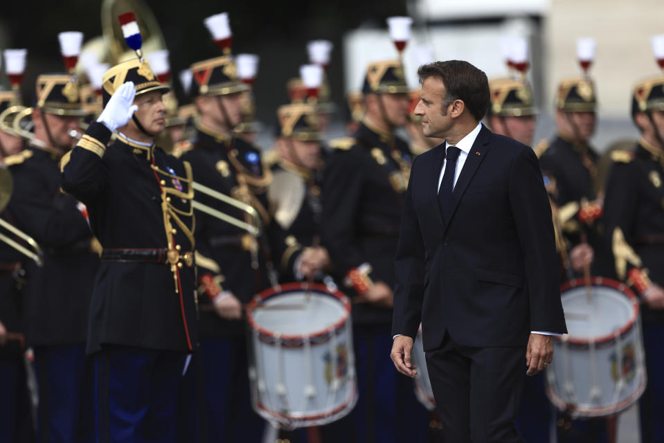 French President Emmanuel Macron reviews the Republican Guard during the Bastille Day military parade Friday, July 14, 2023 in Paris. India is the guest of honor at this year's Bastille Day parade, with Prime Minister Narendra Modi in the presidential tribune alongside French President Emmanuel Macron. (AP Photo/Aurelien Morissard)