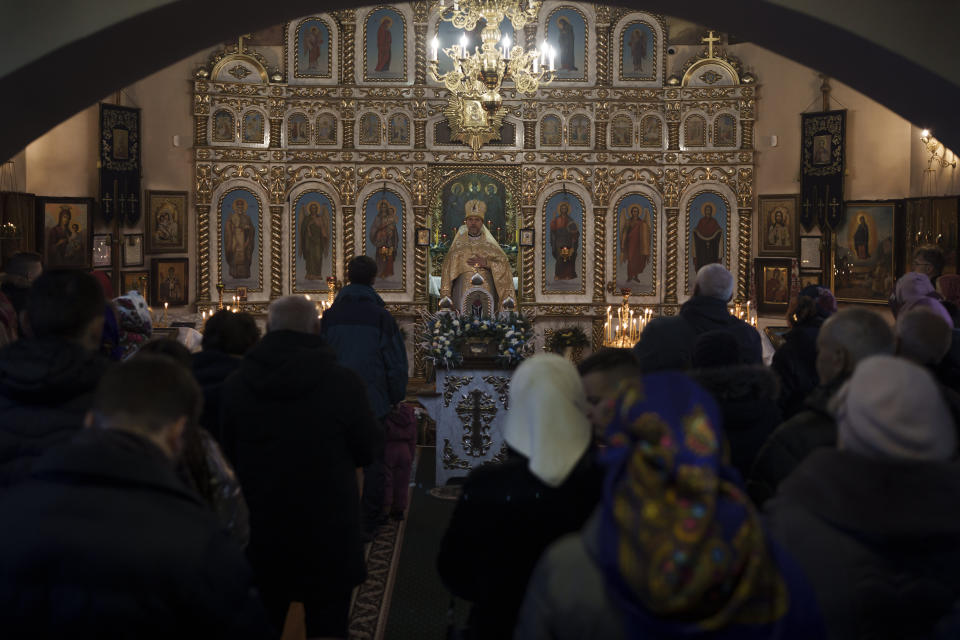 Ukrainians attend a Christmas mass at an Orthodox Church in Bobrytsia, outskirts of Kyiv, Ukraine, Sunday, Dec. 25, 2022. Ukrainians usually celebrate Christmas on Jan. 7, as do Russians. Not this year, or at least not all of them. Some Orthodox Ukrainians have decided to observe Christmas on Dec. 25, like many Christians around the world. (AP Photo/Felipe Dana)