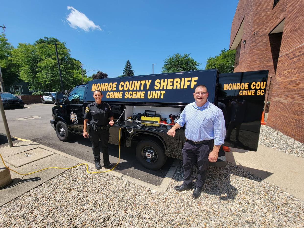 Monroe County Sheriff's Detective Margie Martin (left) and Undersheriff Jeff Pauli stand next to the Crime Scene Unit, the agency's new forensic van.