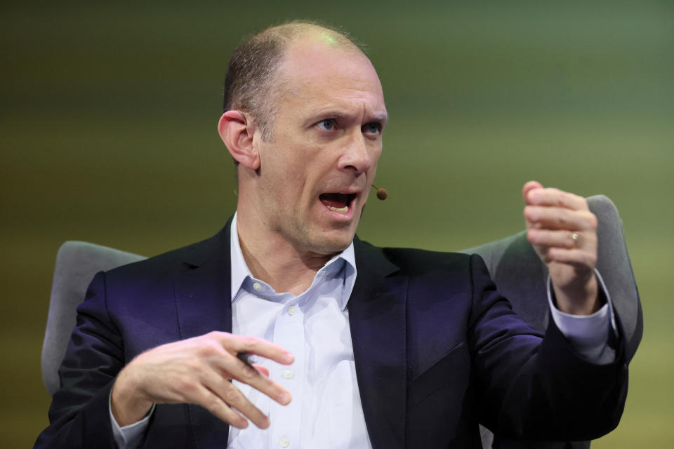 Chicago Fed President Austan Goolsbee gestures while speaking at an event.