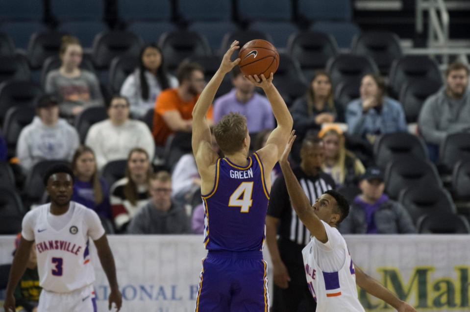 Northern Iowa's AJ Green (4) shots over Evansville’s Preston Phillips (24) as the University of Evansville Purple Aces take on the University of Northern Iowa Panthers at Ford Center in Evansville, Ind., Wednesday evening, Jan. 26, 2022. 