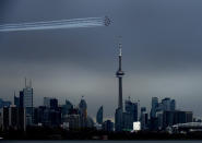 The Canadian Snowbirds circle the CN Tower as part of Operation Inspiration during the COVID-19 pandemic in Toronto on Sunday, May 10, 2020. (Nathan Denette/The Canadian Press via AP)