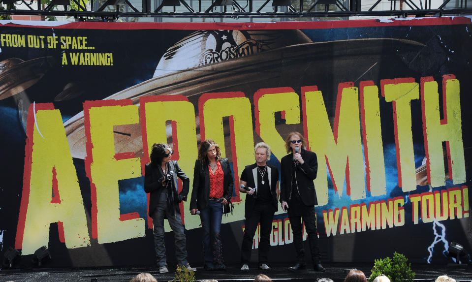 Joe Perry, from left, Steven Tyler, Joey Kramer, and Tom Hamilton of Aerosmith, speak at the Aerosmith news conference announcing the 2012 Global Warming Tour, Wednesday, March 28, 2012, at The Grove in Los Angeles. The Global Warming Tour will play 18 markets beginning on June 16, 2012, in Minneapolis. (AP Photo/Katy Winn)