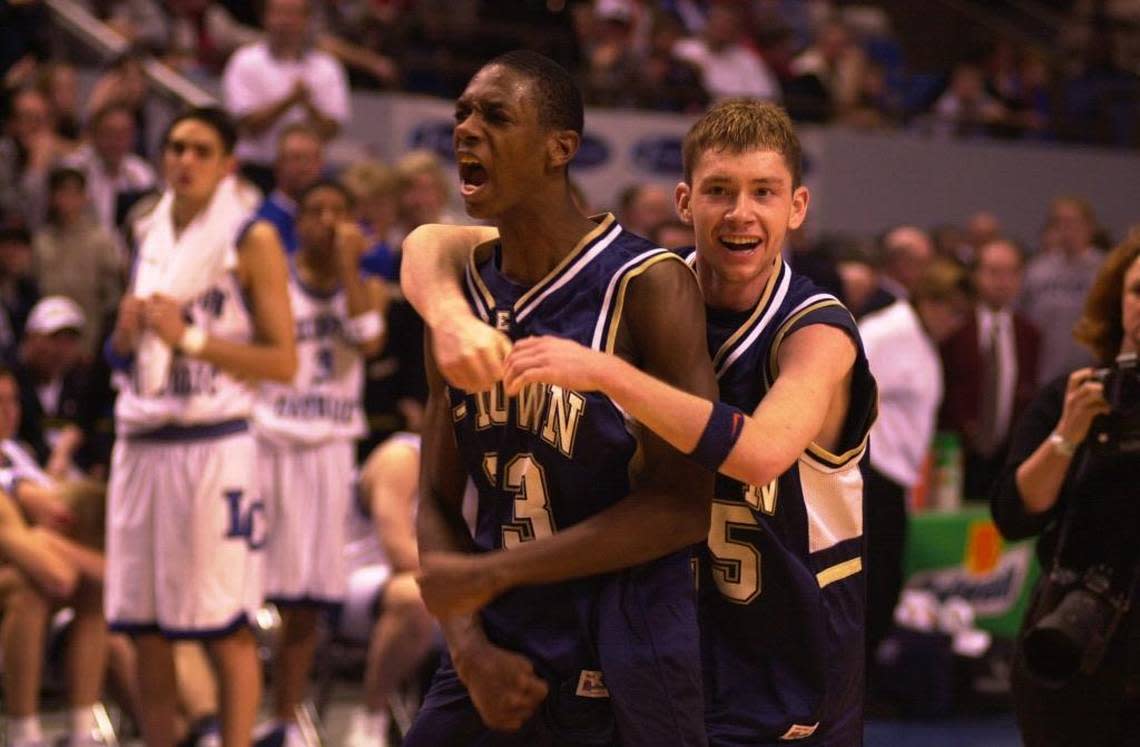 Elizabethtown’s Antwain Barbour got a hug from teammate Josh Pedigo, right, after Barbour scored 31 points to lead the Panthers to a 79-69 win over Lexington Catholic in the 2000 state championship game.