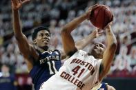 Boston College's Steffon Mitchell (41) tries to get a shot off against Notre Dame's Juwan Durham (11) during the second half of an NCAA college basketball game, Saturday, Feb. 27, 2021, in Boston. (AP Photo/Michael Dwyer)