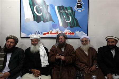 Maulana Sami ul-Haq (C), one of the Taliban negotiators, flanked by his team members Ibrahim Khan (2nd L) and Maulana Abdul Aziz (2nd R), gestures before a news conference in Islamabad February 4, 2014. REUTERS/Mian Khursheed