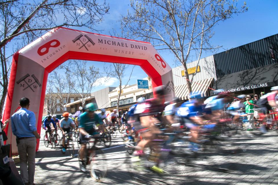 Riders take off at the start of the Mens Cat 3/4 race in the annual Lodi Cyclefest in downtown Lodi. Wood would eventually win the race on Apr. 7, 2019. A slow shutter speed blurs the movment of the riders.