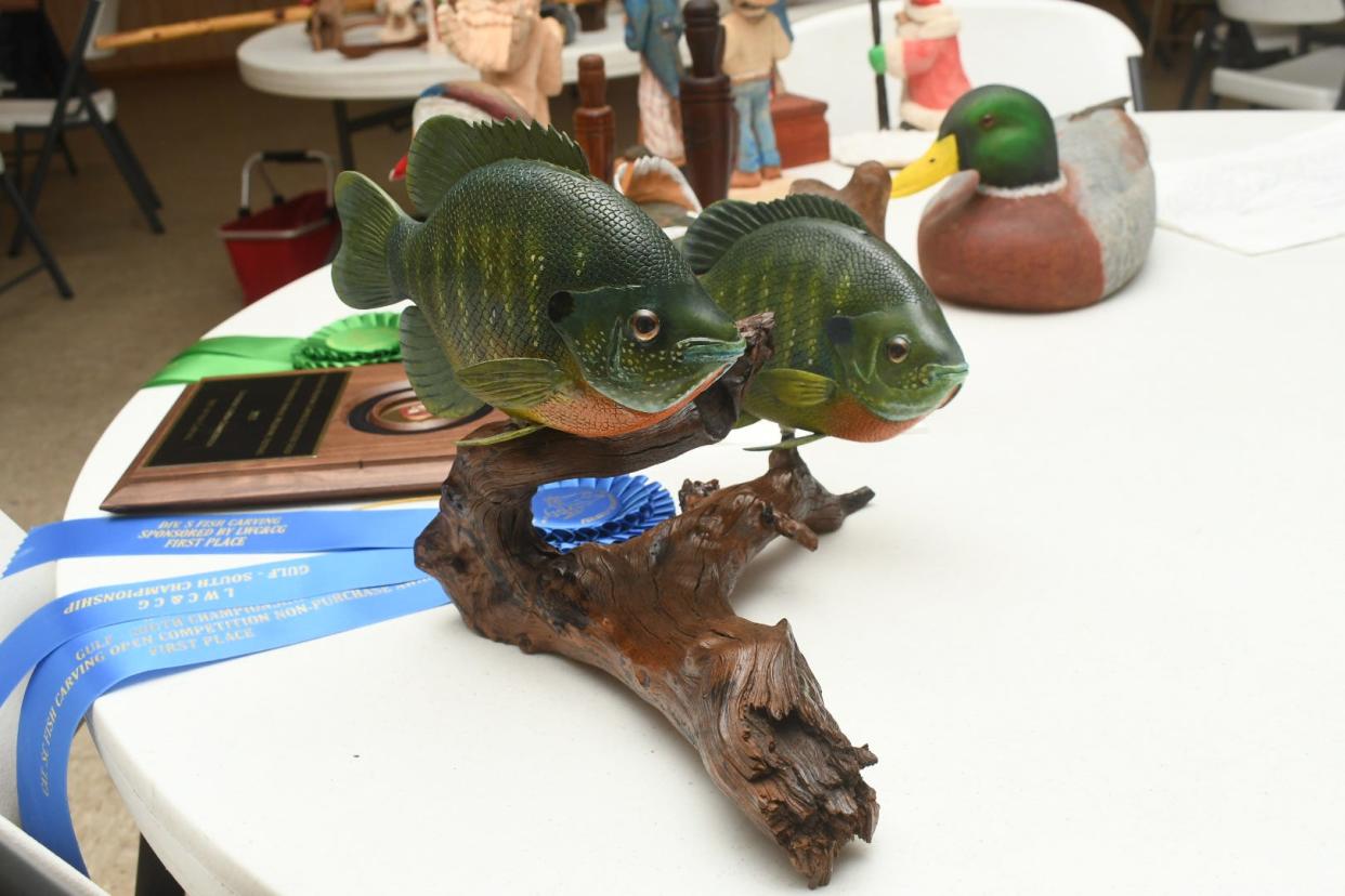 On a nearby table are fish, duck calls and duck carvings along with ribbons Jimmy Crooks won from the Louisiana Wildfowl Carvers & Collectors Guild this year. A carving he did of two fish won first place and a cowboy caricature placed third.