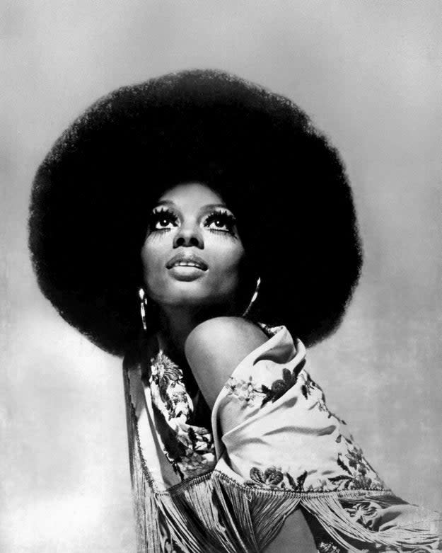 Diana Ross is pictured gazing upwards with a large afro hairstyle, wearing a patterned shawl