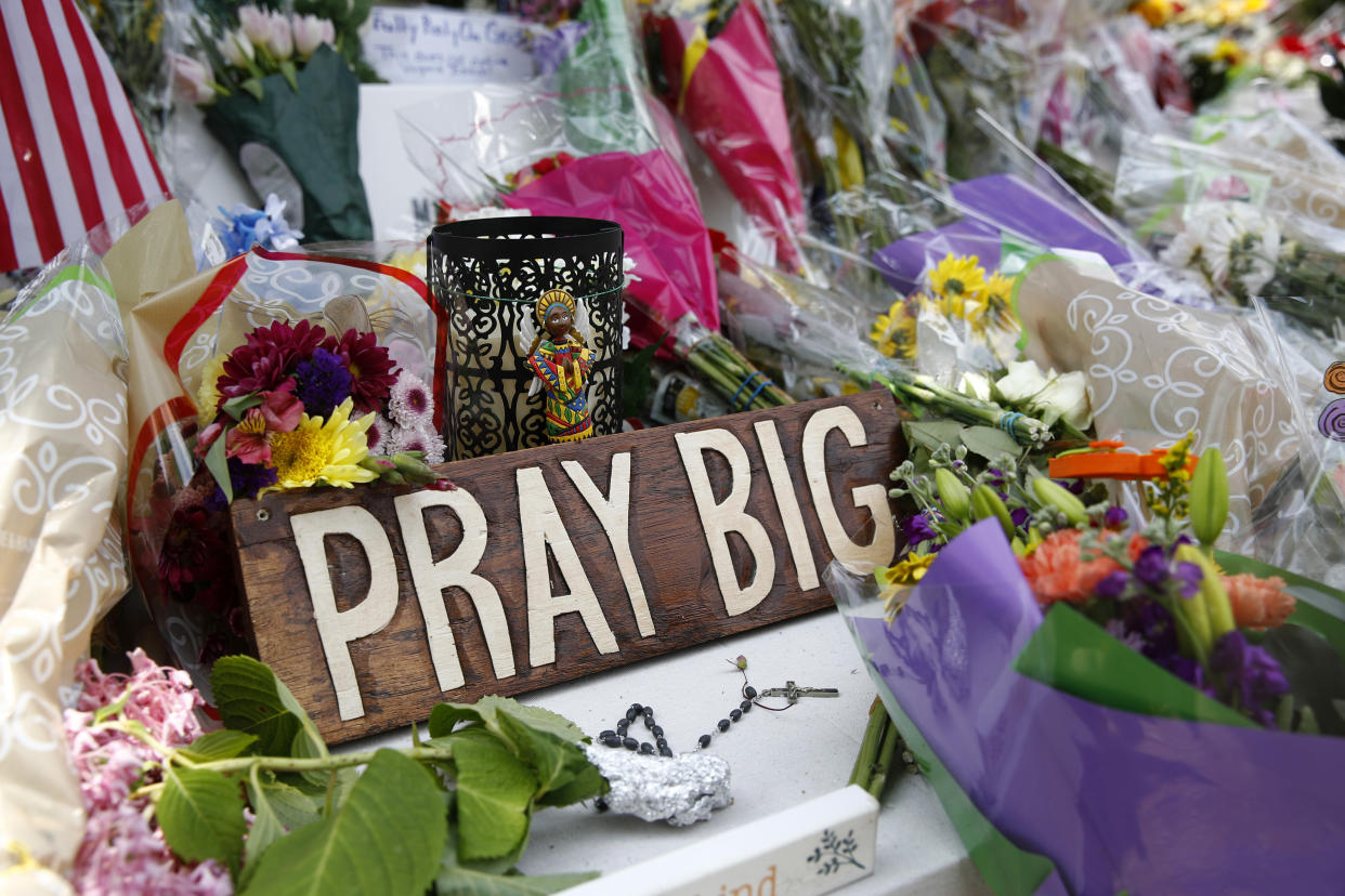 A sign sits among flowers and mementos left at a makeshift memorial for victims of a mass shooting at a municipal building in Virginia Beach, Va. (Photo: Patrick Semansky/AP)