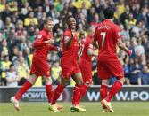 Liverpool's Raheem Sterling (C) celebrates his goal against Norwich City with teammates Lucas Leiva (L) and Luis Suarez during their English Premier League soccer match at Carrow Road in Norwich April 20, 2014. REUTERS/Stefan Wermuth