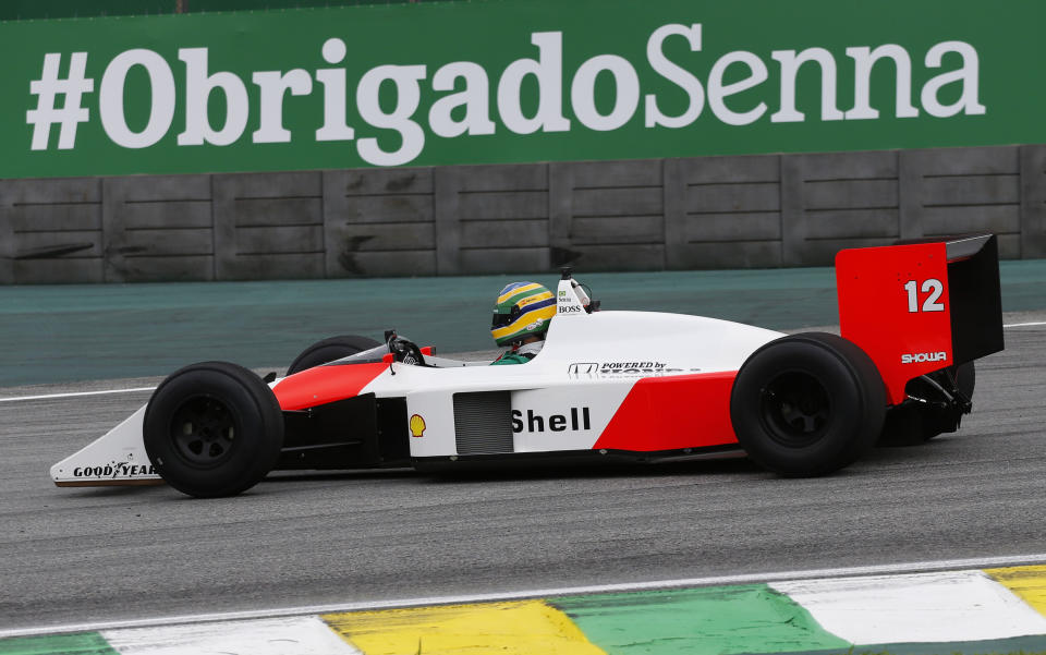 Driver Bruno Senna steers the McLaren used by the Brazilian F1 driver Ayrton Senna in 1988, at the Interlagos racetrack in Sao Paulo, Brazil, Thursday, Nov. 14, 2019. (AP Photo/Nelson Antoine)