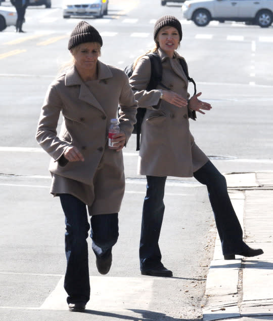 <p>In the same double-breasted coat and beanie, Angelina Jolie is seen on the set of <i>Salt</i> in Washington, D.C., with her double, who doesn’t look anything like the Oscar winner. <br></p><p><i>(Photo: Splash News)</i></p>