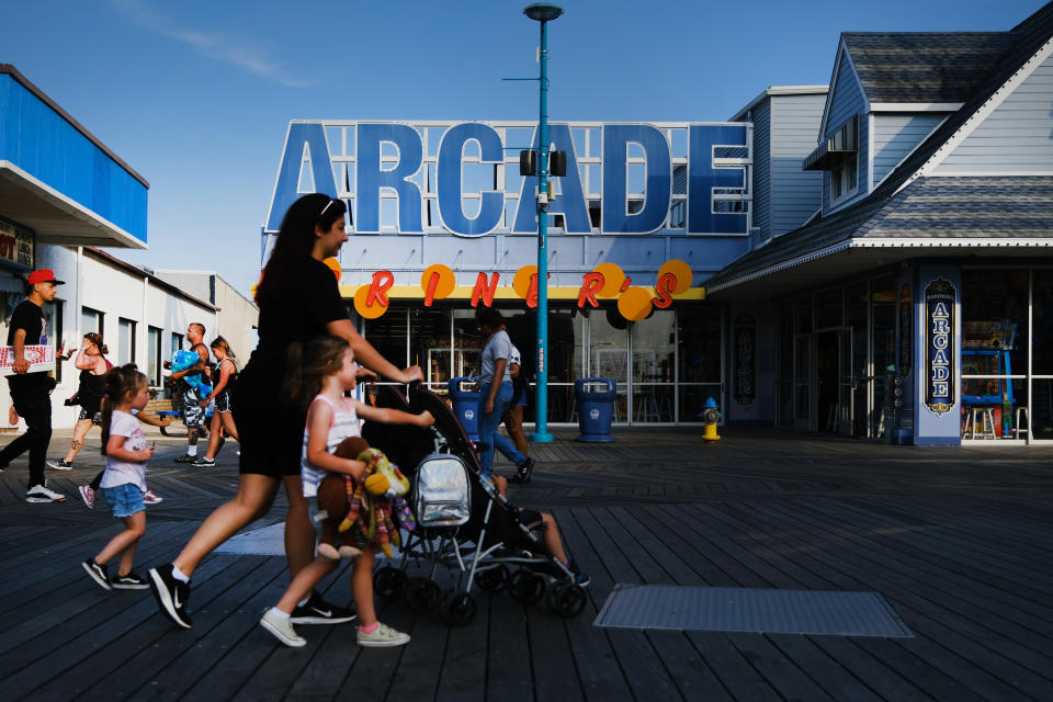 WILDWOOD, NEW JERSEY - MAY 27: People walk along the boardwalk days before the Memorial Day weekend, the un-official start of summer, on the Jersey shore on May 27, 2021 in Wildwood, New Jersey. Wildwood, like many beach communities throughout the United States, is looking for a successful and busy summer season after staying mostly closed or partially open last summer due to Covid-19 restrictions. Many resort community retail businesses are also suffering from a shortage of labor as some workers are choosing to stay home and others have changed career paths.  (Photo by Spencer Platt/Getty Images)