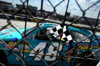 DOVER, DE - JUNE 03: Jimmie Johnson, driver of the #48 Lowe's Madagascar Chevrolet, celebrates with the checkered flag after winning the NASCAR Sprint Cup Series FedEx 400 benefiting Autism Speaks at Dover International Speedway on June 3, 2012 in Dover, Delaware. (Photo by Patrick Smith/Getty Images for NASCAR)