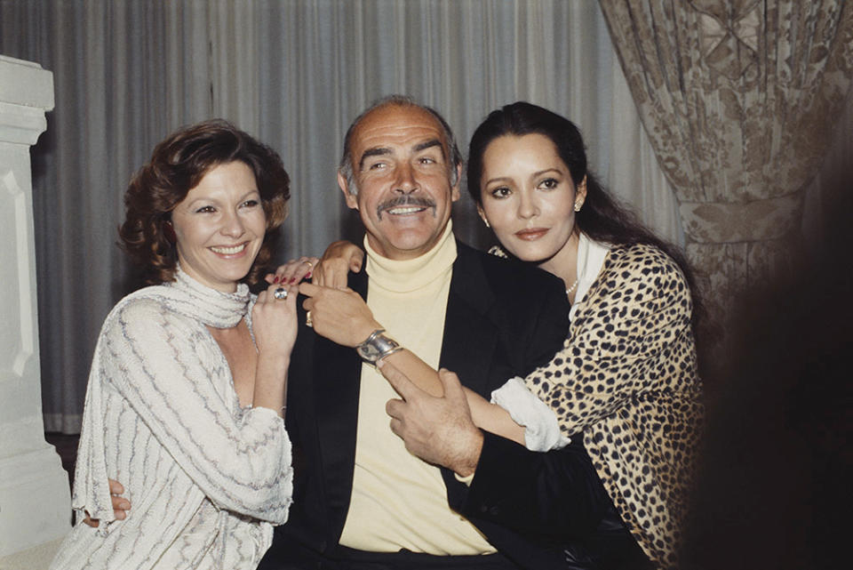 From left to right, actors Pamela Salem, Sean Connery and Barbara Carrera during a press launch for the James Bond film 'Never Say Never Again' at the Inn on the Park in London, 12th December 1983. They play Miss Moneypenny, James Bond and Fatima Blush respectively.