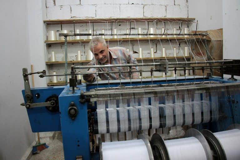 A Syrian man manufactures gause at his factory in Douma, a rebel-held town in the Eastern Ghouta region on October 30, 2017