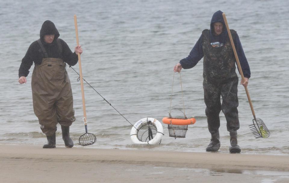Comedians Jimmy Tingle, left, and Lenny Clarke emerge from the water after shooting a clamming scene at Chatham Lighthouse Beach during the filming of a movie short called "Clam Shack Blues."