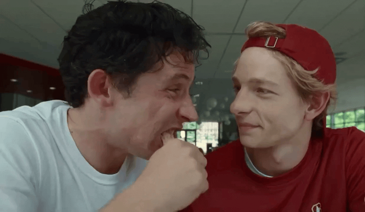 Mike Faist and Josh O'Connor' share a churro in a scene from 'Challengers'