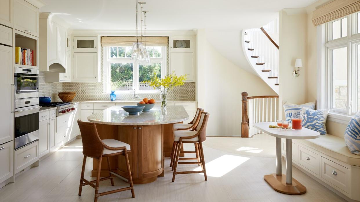 a kitchen with a dining table and chairs