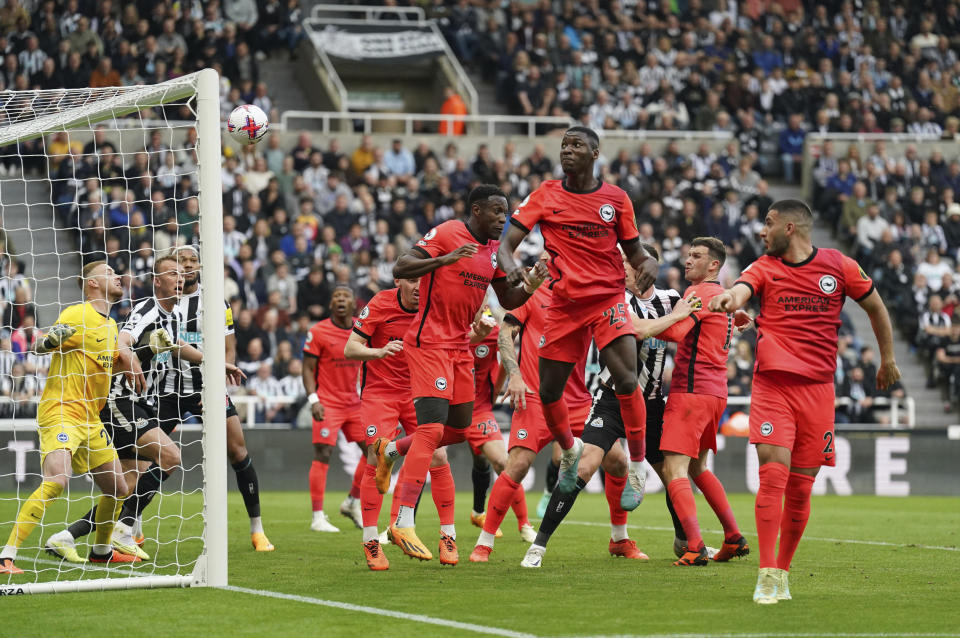 Brighton and Hove Albion's Deniz Undav, right, scores an own goal during the English Premier League soccer match between Brighton and Hove Albion and Newcastle United at St. James' Park, Newcastle, England, Thursday May 18, 2023. (Owen Humphreys/PA via AP)