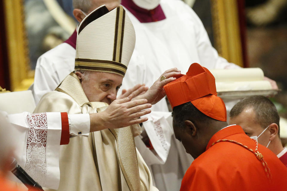 Rwandan newly Cardinal Antoine Kambanda receives his biretta as he is appointed cardinal by Pope Francis, during a consistory ceremony where 13 bishops were elevated to a cardinal's rank in St. Peter’s Basilica at the Vatican, Saturday, Nov. 28, 2020. (Fabio Frustaci/POOL via AP)