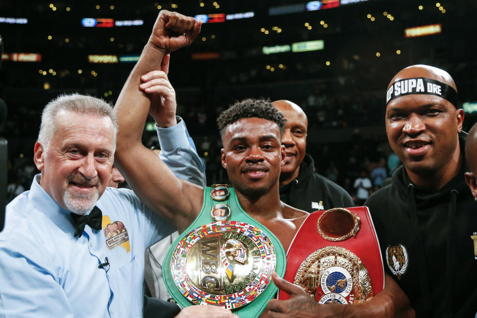 Errol Spence Jr., center, celebrates his victory over Shawn Porter during the WBC & IBF World Welterweight Championship boxing match, Saturday, Sept. 28, 2019, in Los Angeles. (AP Photo/Ringo H.W. Chiu)