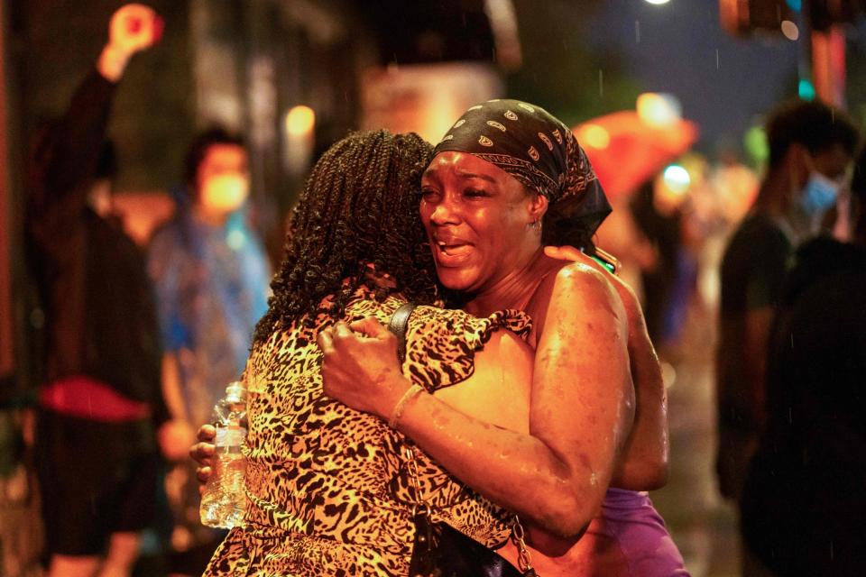 Shawanda Hill, the girlfriend of George Floyd, is comforted by another woman (AFP via Getty Images)