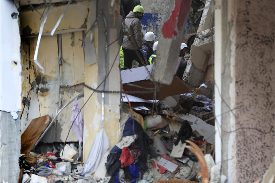 Civil defence and rescue workers remove rubbles from a building that was attacked Wednesday night by an Israeli airstrike, in Nabatiyeh town, south Lebanon, Thursday, Feb. 15, 2024. The airstrike killed and injured several people and child, Lebanon's state news agency reported. (AP Photo/Mohammed Zaatari)