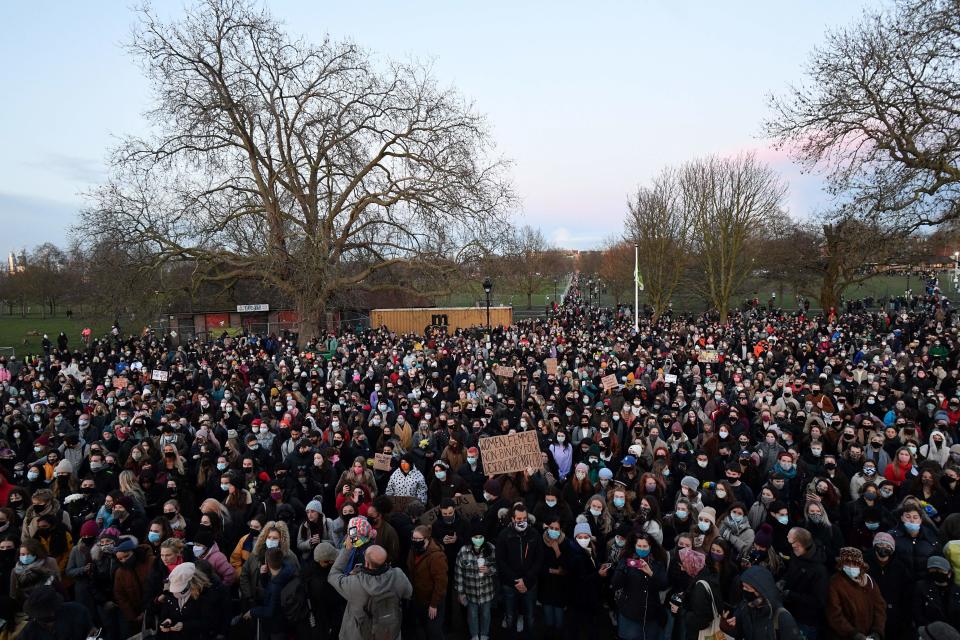 Well-wishers at a band-stand where a planned vigil in honour of murder victim Sarah Everard was cancelled after police outlawed it due to Covid-19 restrictions, on Clapham Common, south London on March 13, 2021, - The police officer charged with murdering  young Londoner, Sarah Everard, who disappeared while walking home from a friend's house, appeared in court on March 13, 2021, as organisers cancelled a vigil in her honour due to coronavirus restrictions. (Photo by JUSTIN TALLIS / AFP) (Photo by JUSTIN TALLIS/AFP via Getty Images)