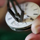 Mike Conroy - owner of Ye Old Watch shop in Portsmouth, Va. removes the second hand from an antique pocket watch.