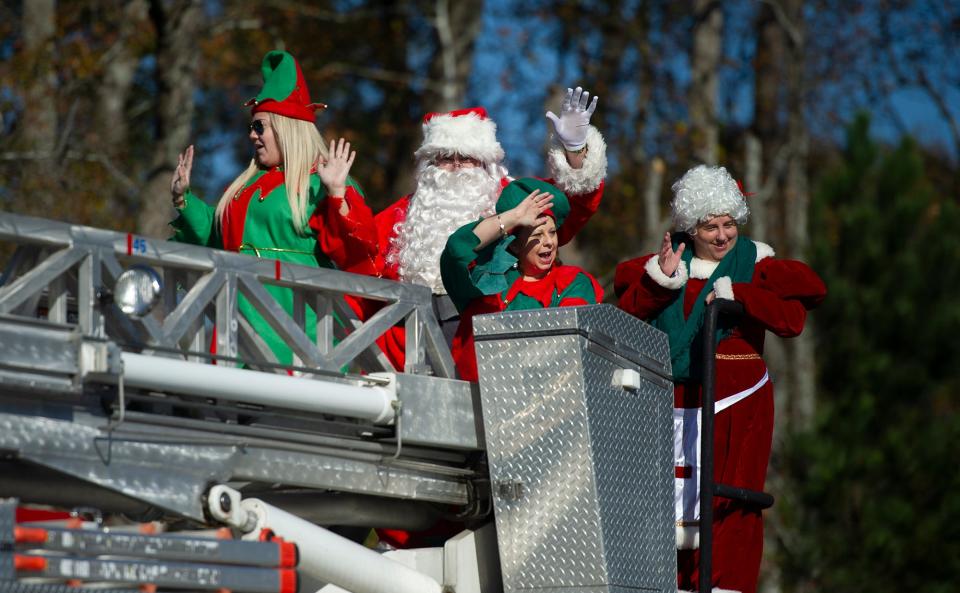 Santa, Mrs. Claus and a few of their favorite elves greet parade goers with a wave from atop a firetruck during the 2020 Grovetown Christmas parade.