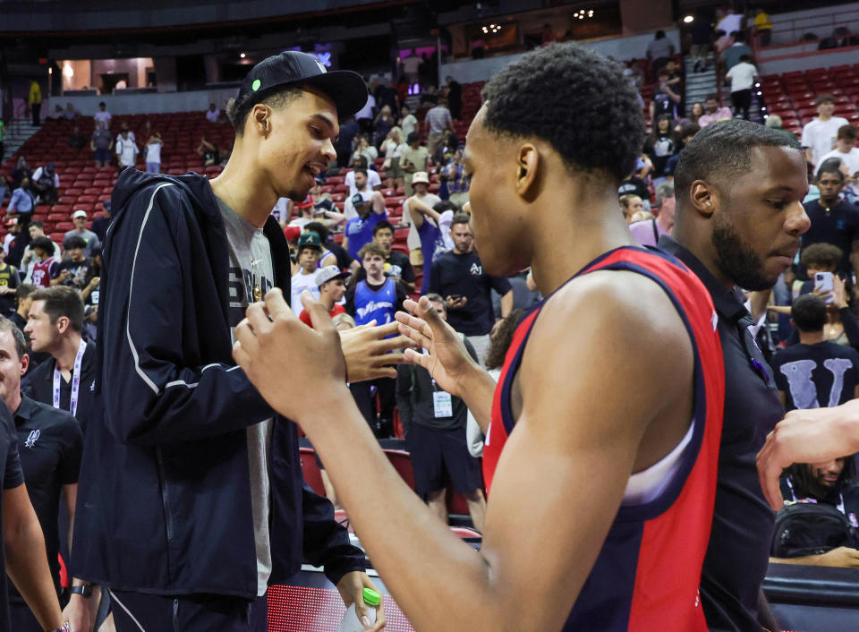 LAS VEGAS, NEVADA - JULY 11: Victor Wembanyama (L) #1 of the San Antonio Spurs greets his former Boulogne-Levallois Metropolitans 92 teammate, Bilal Coulibaly #0 of the Washington Wizards, after a 2023 NBA Summer League game at the Thomas & Mack Center on July 11, 2023 in Las Vegas, Nevada. NOTE TO USER: User expressly acknowledges and agrees that, by downloading and or using this photograph, User is consenting to the terms and conditions of the Getty Images License Agreement.  (Photo by Ethan Miller/Getty Images)