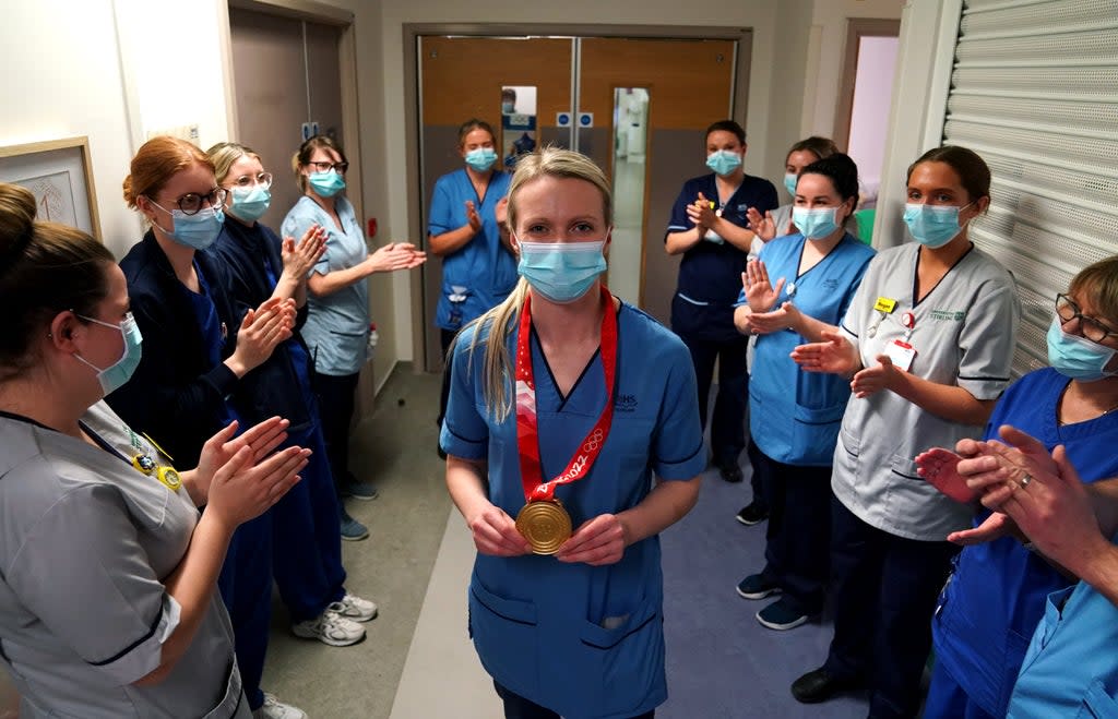 Olympic gold medal winning curler Vicky Wright is clapped onto the ward by colleagues (Andrew Milligan/PA) (PA Wire)