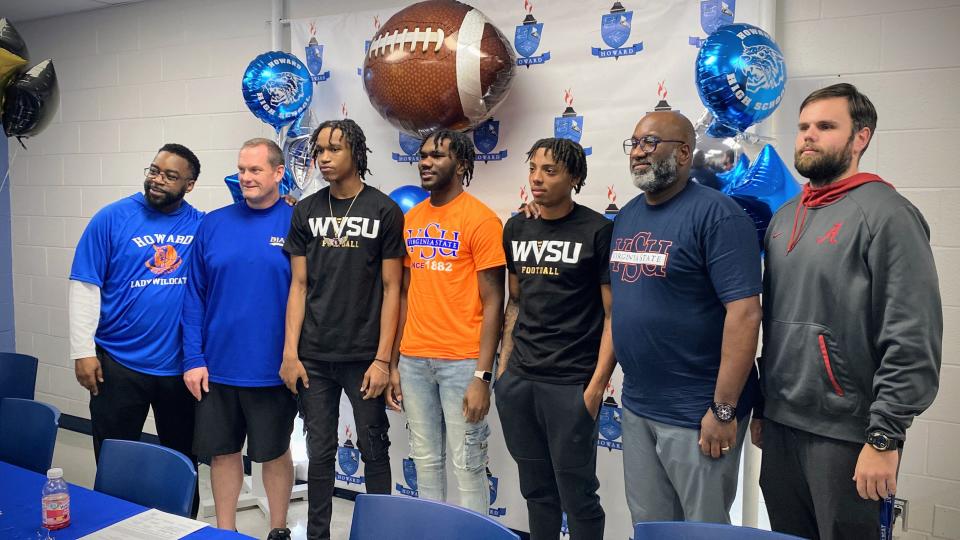 Jamal Johnson, R.J. Matthews and Robert Kelly pose with members of the Howard coaching staff on National Signing Day Feb. 7, 2024.