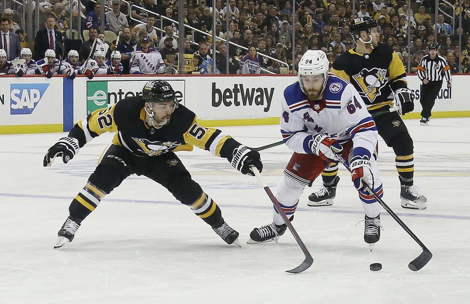 May 13, 2022; Pittsburgh, Pennsylvania, USA;  New York Rangers center Tyler Motte (64) skates with the puck as Pittsburgh Penguins defenseman Mark Friedman (52) defends during the third period in game six of the first round of the 2022 Stanley Cup Playoffs at PPG Paints Arena. The Rangers won 5-3.