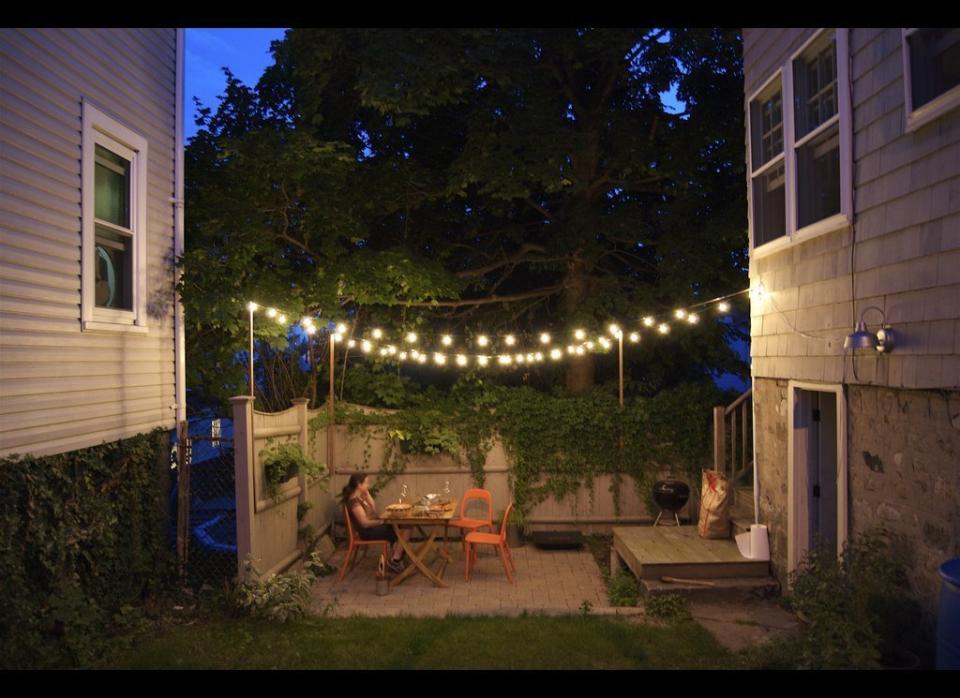 Not only is it easy to install, but ambient lighting will set the perfect mood for your outdoor parties. The key to getting them to stay up? Screw-in (or use heavy duty adhesive) hooks. Just drape lights between hooks, making sure that the end plug is near an electrical source. To see more details, head over to <a href="http://www.homeandgardenideas.com/outdoor-living/outdoor-decor/lighting/how-hang-string-lighting-outdoor-party" target="_hplink">Home & Garden Ideas</a>.    Flickr photo by <a href="http://www.flickr.com/photos/johnclarkemills/3367852369/in/photostream/" target="_hplink">johnclarkemills</a>