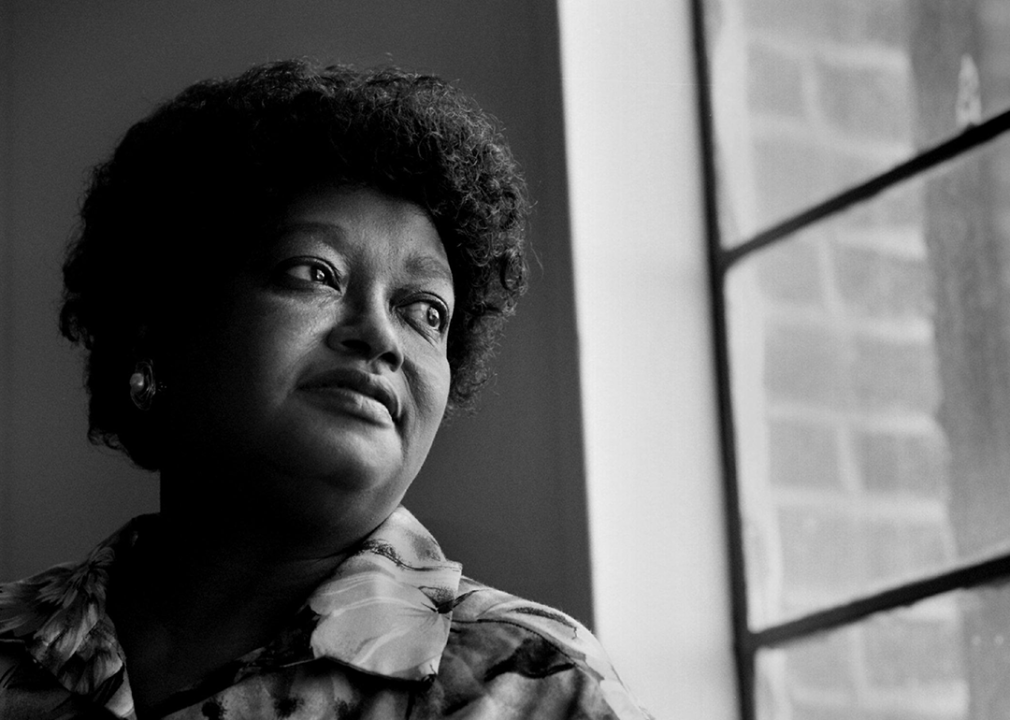 Portrait of Claudette Colvin standing by window.