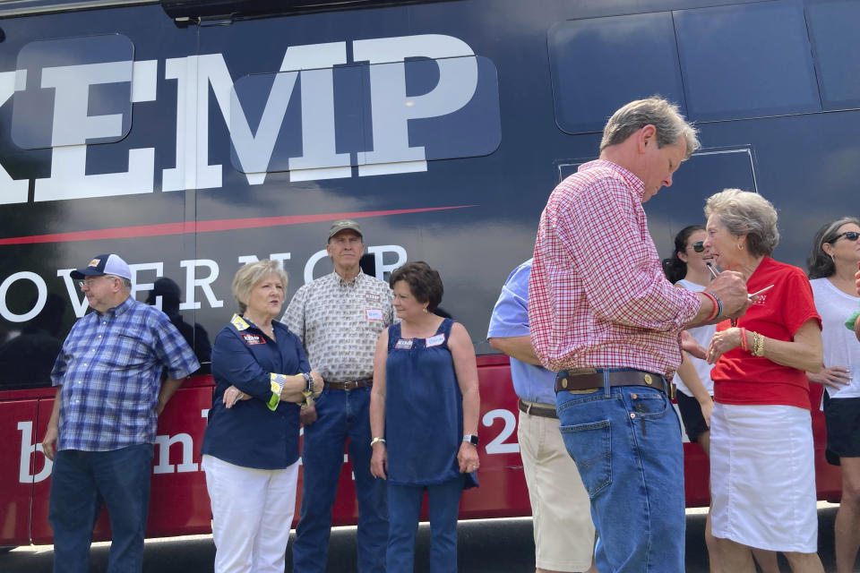 Georgia Gov. Brian Kemp makes notes before giving a speech on Saturday, May 21, 2022, in Watkinsville, Ga. The Republican Kemp is seeking to beat former U.S. Sen David Perdue and others in a Republican primary for governor on Tuesday, May 24, 2022 (AP Photo/Jeff Amy)