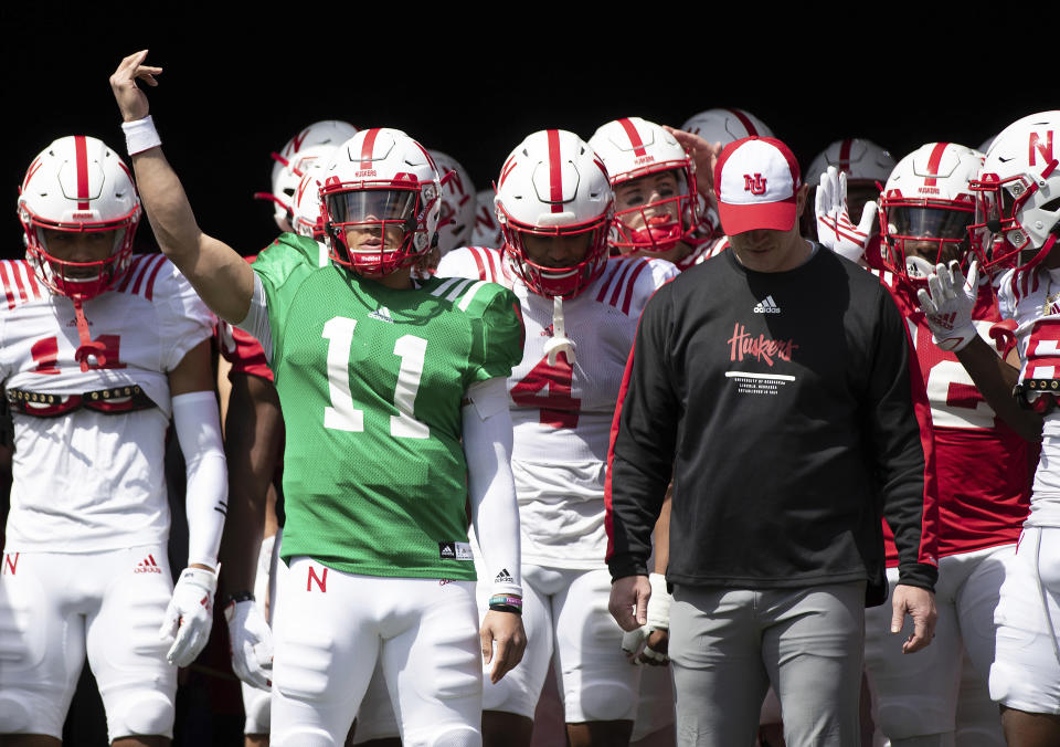 FILE - Nebraska red team quarterback Casey Thompson (11) signals the crowd before leading both the red and white teams onto the field alongside head coach Scott Frost before Nebraska's NCAA college football annual red-white spring game at Memorial Stadium in Lincoln, Neb., Saturday, April 9, 2022. Nebraska starts Aug. 27 against Northwestern in Dublin, Ireland. (AP Photo/Rebecca S. Gratz, File)