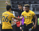 Wolverhampton Wanderers' Hwang Hee-chan walks off after being substituted by Wolverhampton Wanderers' Adama Traore, right, during the English Premier League soccer match between Wolverhampton Wanderers and Newcastle United at Molineux stadium in Wolverhampton, England, Saturday, Oct. 2, 2021. (AP Photo/Rui Vieira)