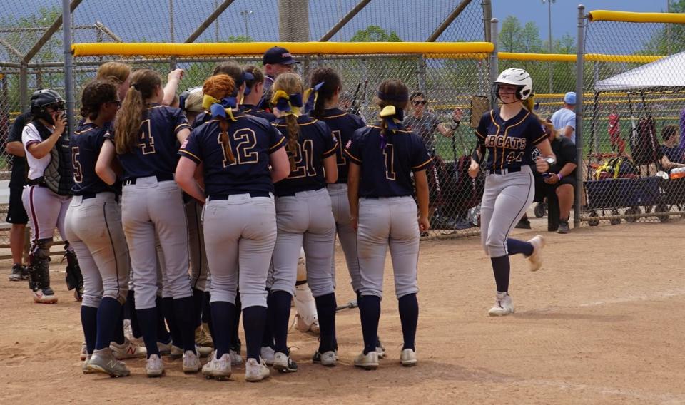 Berlynn Keller is greeted by her Whiteford teammates after a home run in the Michigan Challenge Tournament Sunday.