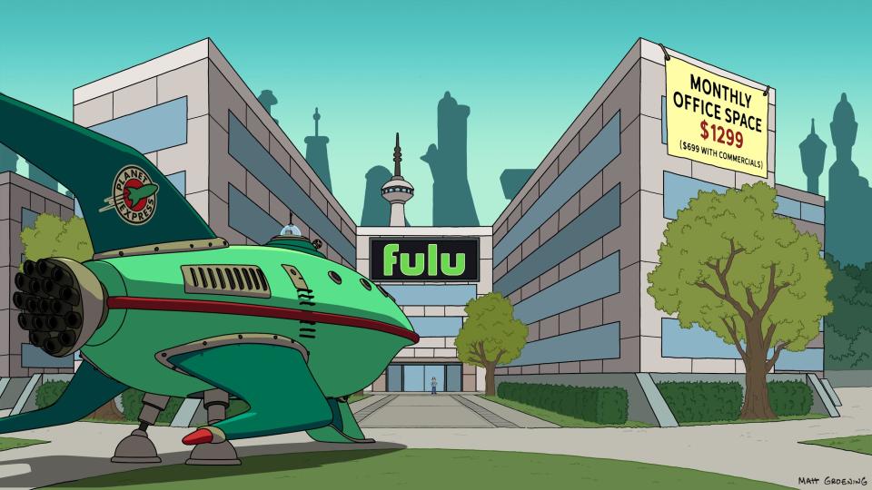 a green spaceship sits in front of an office building whose sign reads 