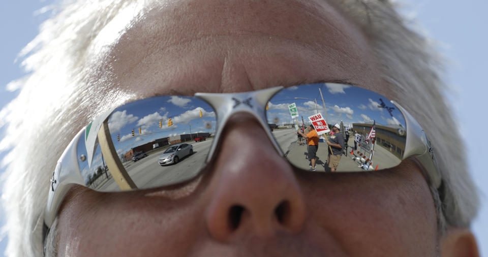 Dion Pepa, a technician with GM for 20 years, pickets outside the General Motors Fabrication Division, Monday, Sept. 23, 2019, in Parma, Ohio. The strike against General Motors by 49,000 United Auto Workers entered its second week Monday with progress reported in negotiations but no clear end in sight. (AP Photo/Tony Dejak)