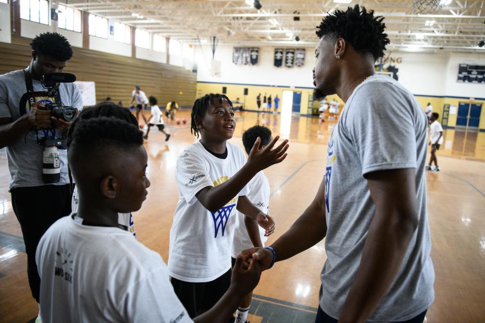 Fayetteville native, NBA player Dennis Smith Jr. talks with the kids attending his Smithway Youth Basketball Camp at E.E. Smith High School on Wednesday, June 29, 2022.