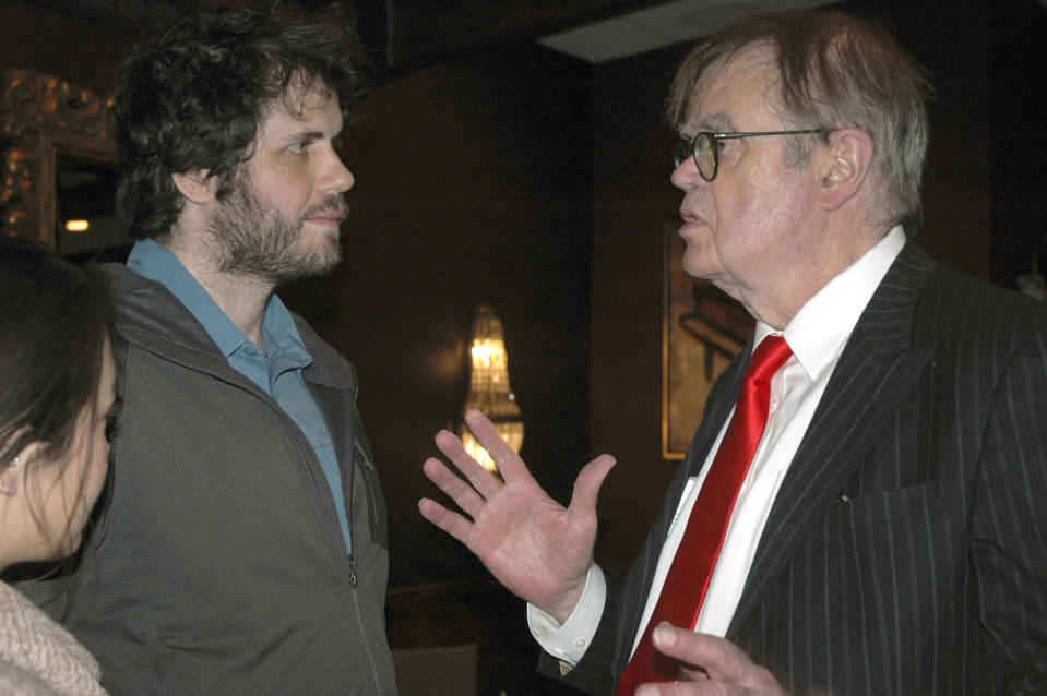 In this Sunday, Dec. 16, 2018, former "A Prairie Home Companion" host Garrison Keillor, right, talks to fans after his performances at Crooners lounge in Fridley, Minn. Keillor is stepping back into the spotlight a year after Minnesota Public Radio cut ties with him over a sexual misconduct allegation. Keillor performed two sold-out shows Sunday night at Crooners, a jazz nightclub in a Minneapolis suburb near where he grew up. Fans laughed, applauded and sang along. (AP Photo/Jeff Baenen)