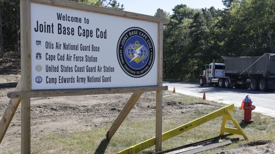 FILE - A truck drives past a welcome sign to Joint Base Cape Cod, Sept. 22, 2014, in Sandwich, Mass. (Steven Senne/AP, File)